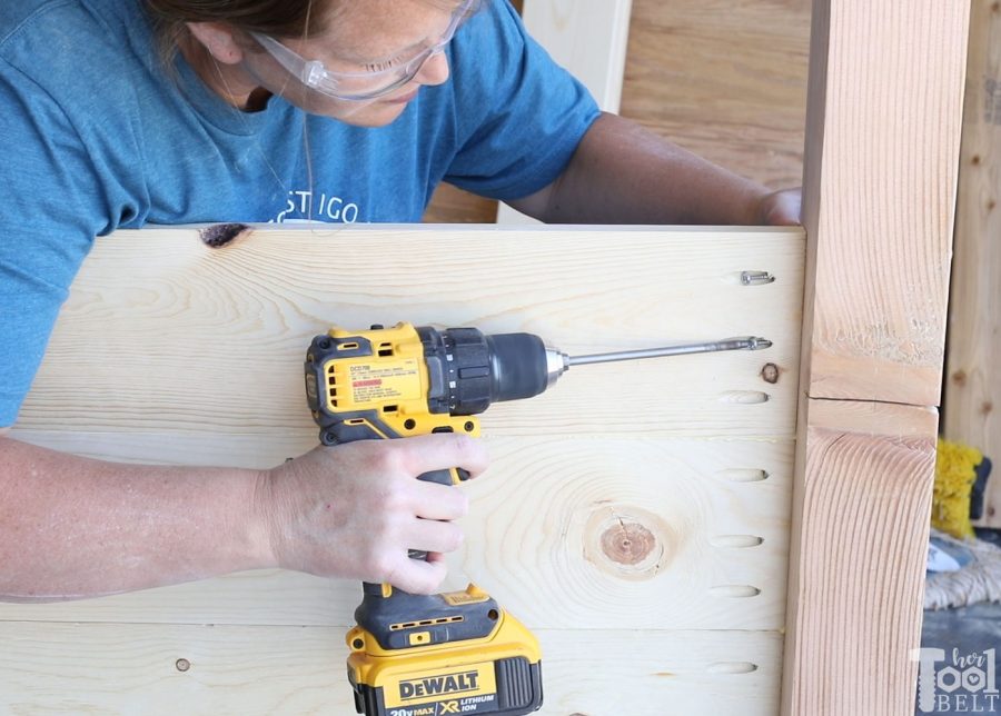 Build a barn door farmhouse bed with X headboard. Free king size bed building plans on hertoolbelt.com.